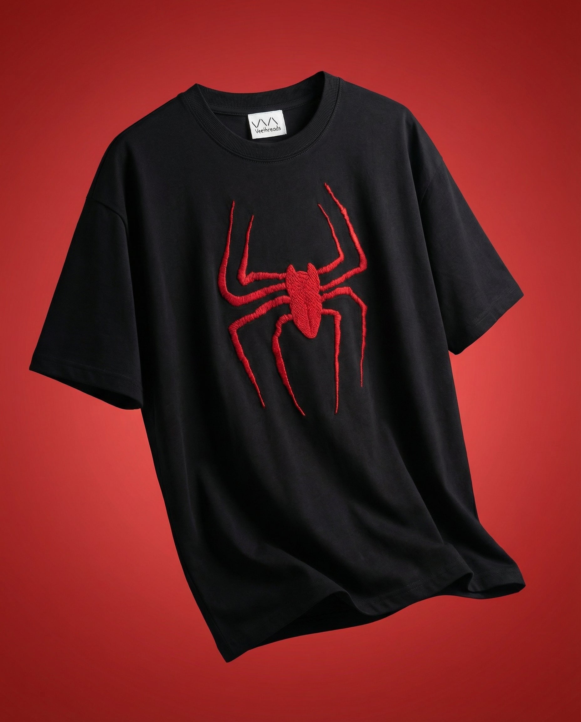 Model wearing a black hand-embroidered spider web oversized cotton t-shirt in a relaxed unisex fit