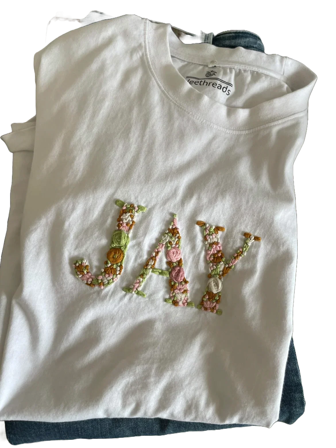 Hand-embroidered custom name on an oversized cotton tee, an Eid gift by Vee Threads