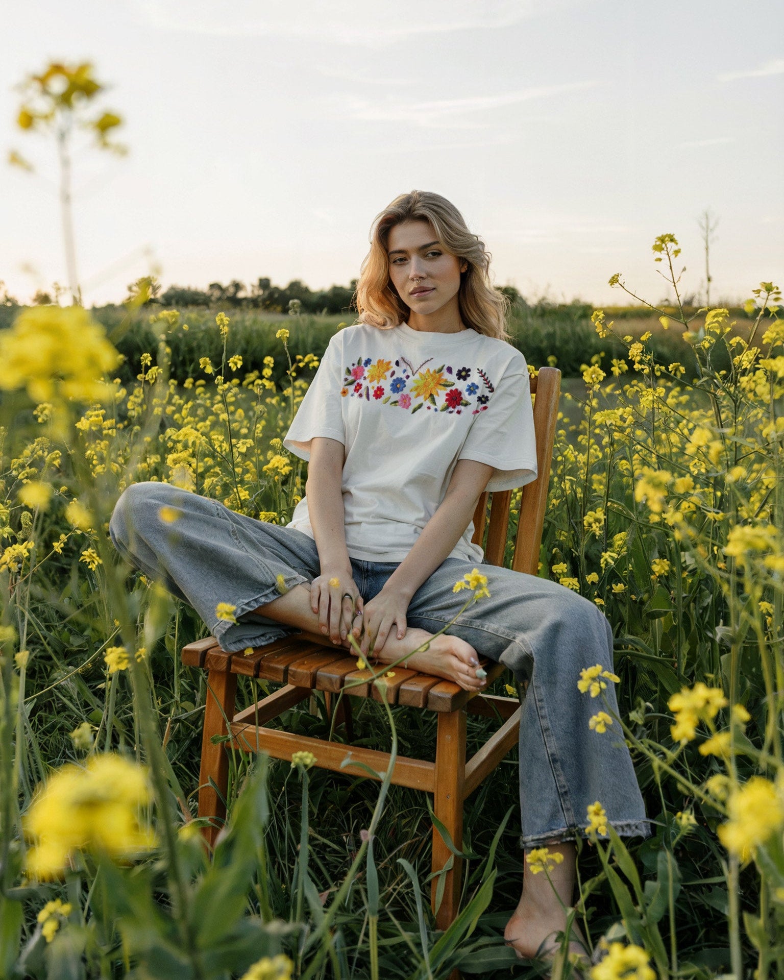 Female model styling oversized floral embroidery t-shirt in casual outdoor look

