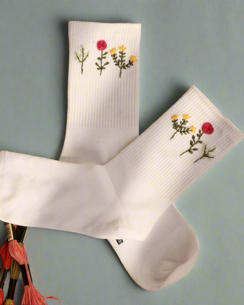 Embroidered socks floral bouquet detail — close-up of hand-embroidered delicate flower bouquet design on white cotton socks