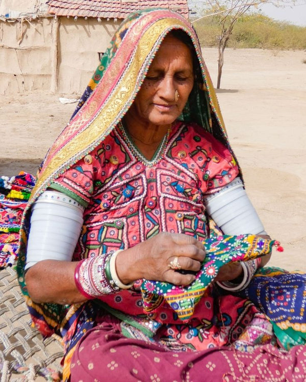 Meera — artisan hand embroidering fabric