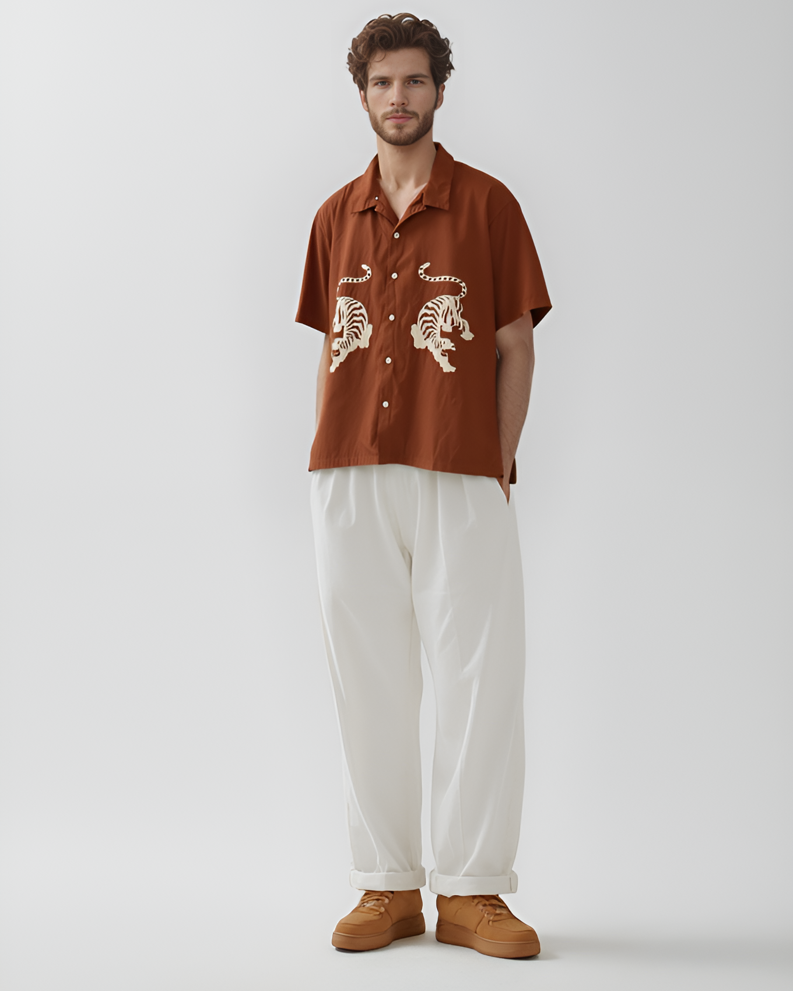 ust brown hand-embroidered men's shirt with Royal Bengal tiger design – sustainable artisan-made shirt styled with white pants, perfect for modern ethical fashion lovers.