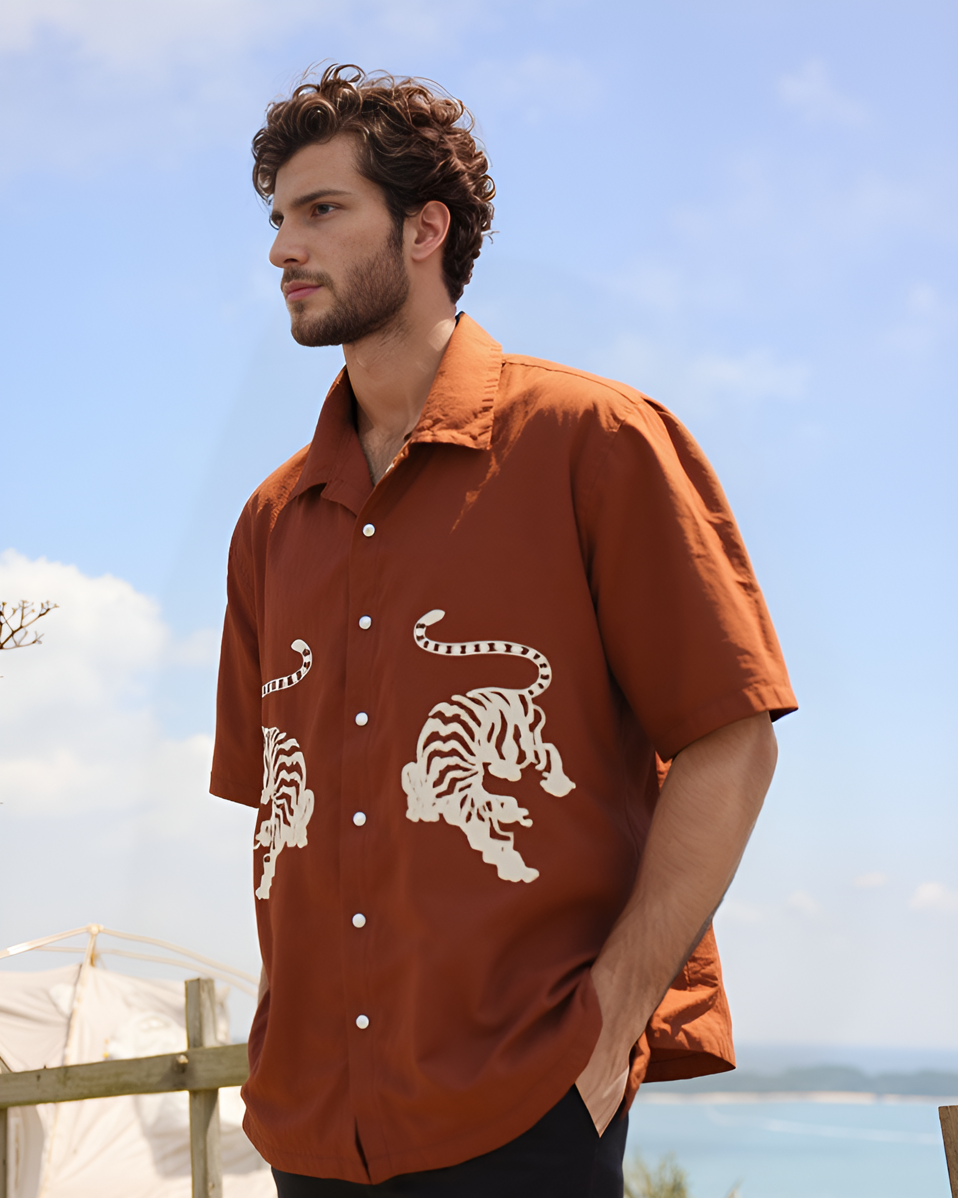 ust brown hand-embroidered men's shirt with Royal Bengal tiger design – sustainable artisan-made shirt styled with white pants, perfect for modern ethical fashion lovers.