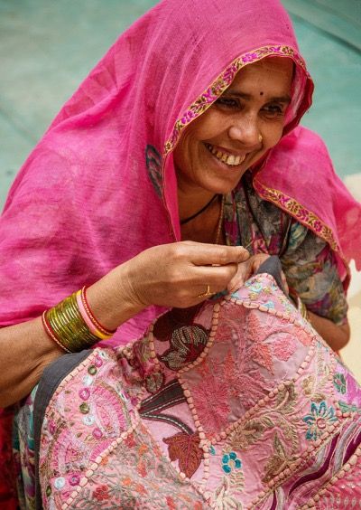 Saba — artisan stitching name on fabric