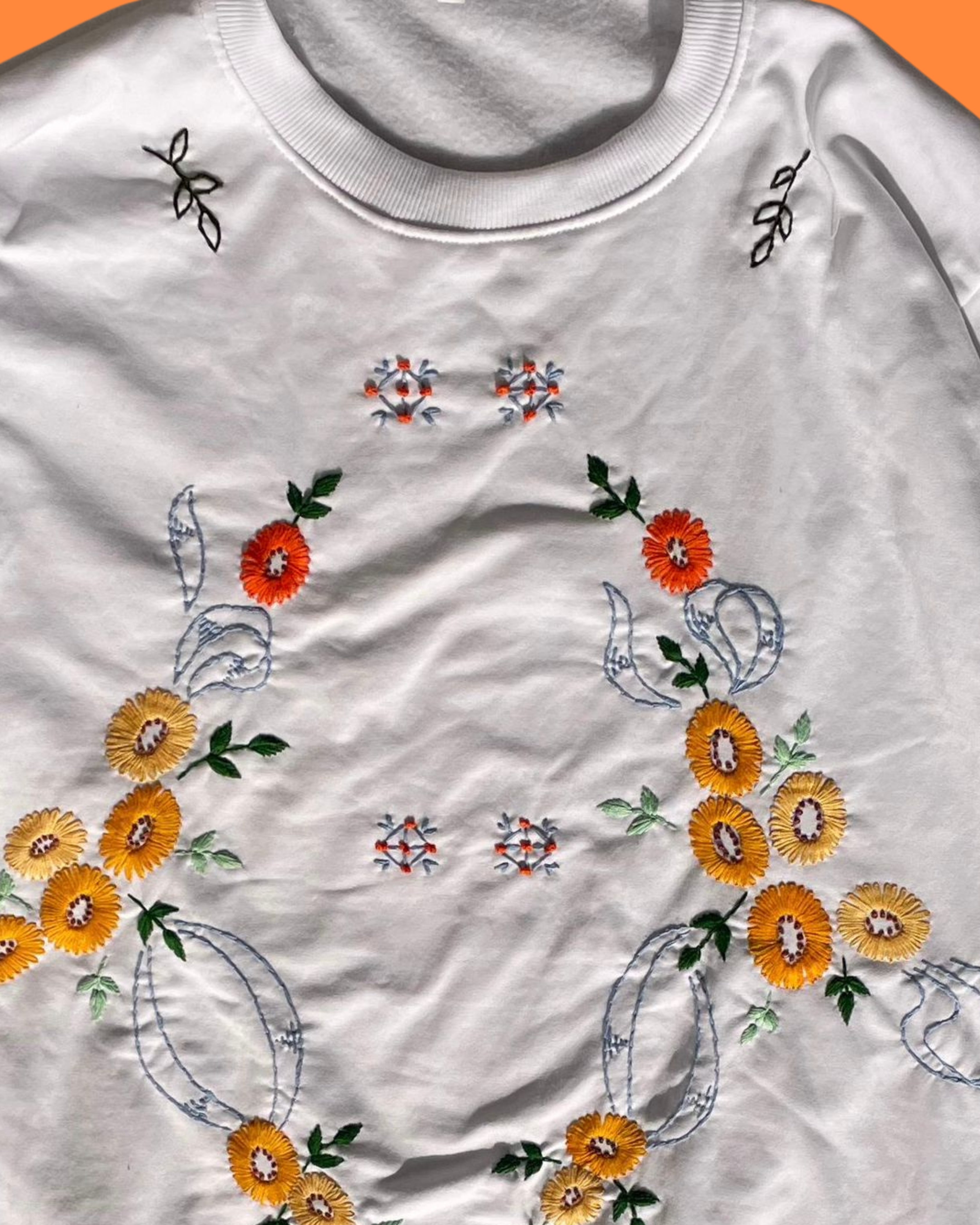 White shirt with floral embroidery on a white background
