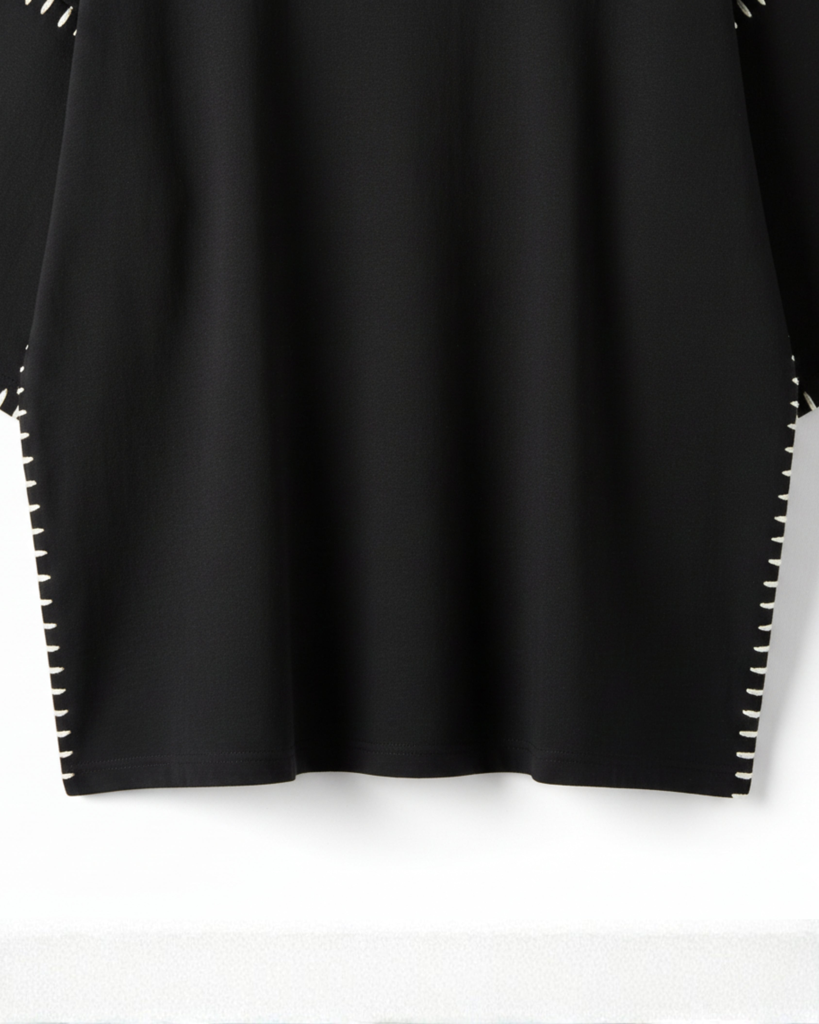 Black top with white trim on a white background