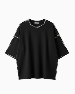 Black sweater with white trim on a white background