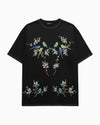 Black t-shirt with colorful bird and floral embroidery on a white background