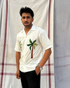 White cotton shirt with hand-embroidered coconut tree – chill beach vibes stitched with desi hands.