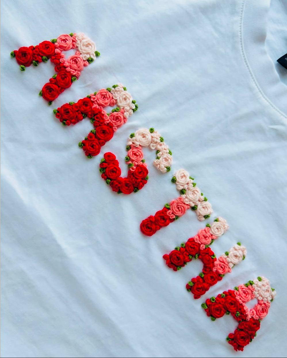 Custom embroidery name double thread tee — hand-embroidered name design with floral details on premium 240 GSM cotton tee