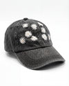 Black denim cap with white floral embroidery on a white background