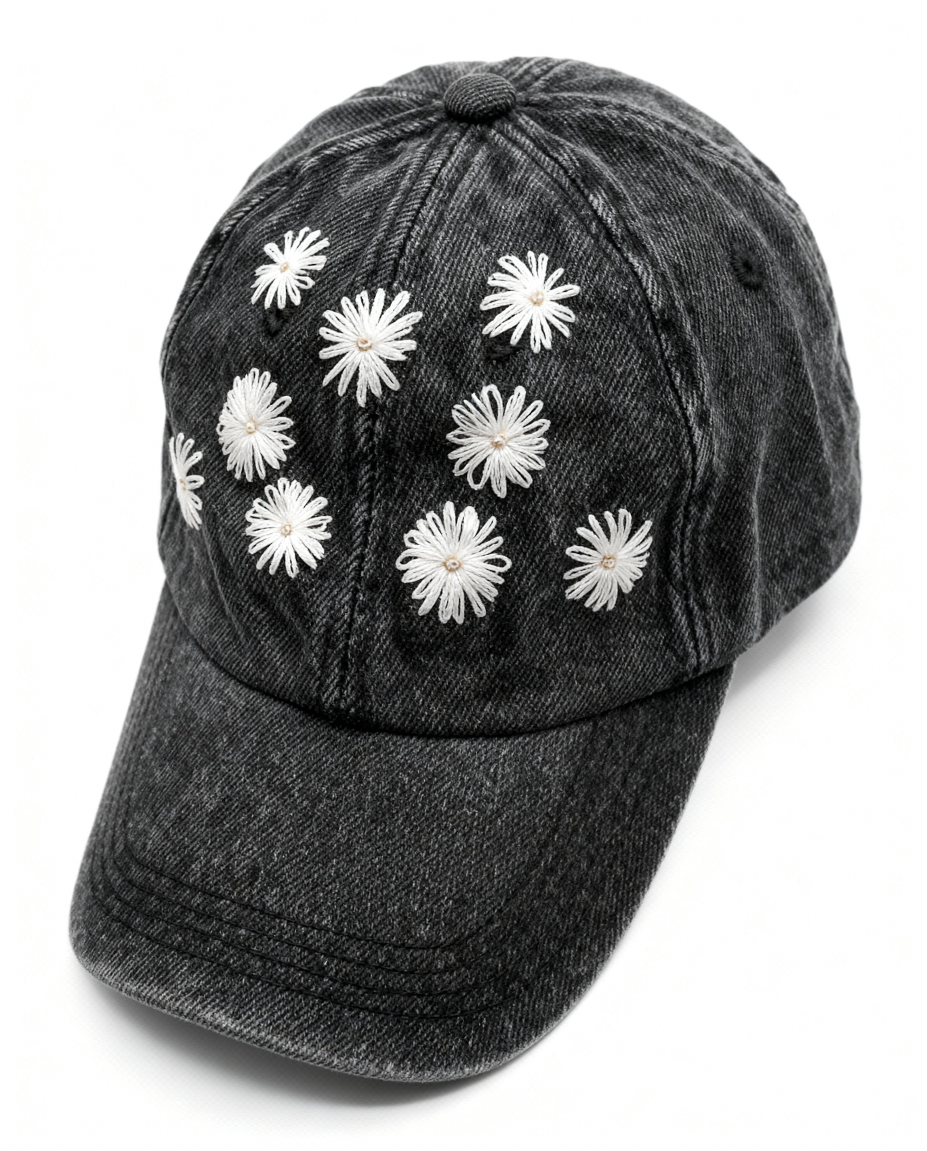 Black denim cap with white floral embellishments  embroidery on a white background