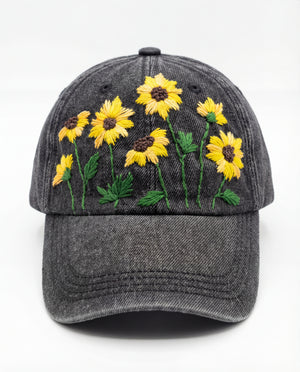 Gray cap with yellow sunflower embroidery on a white background