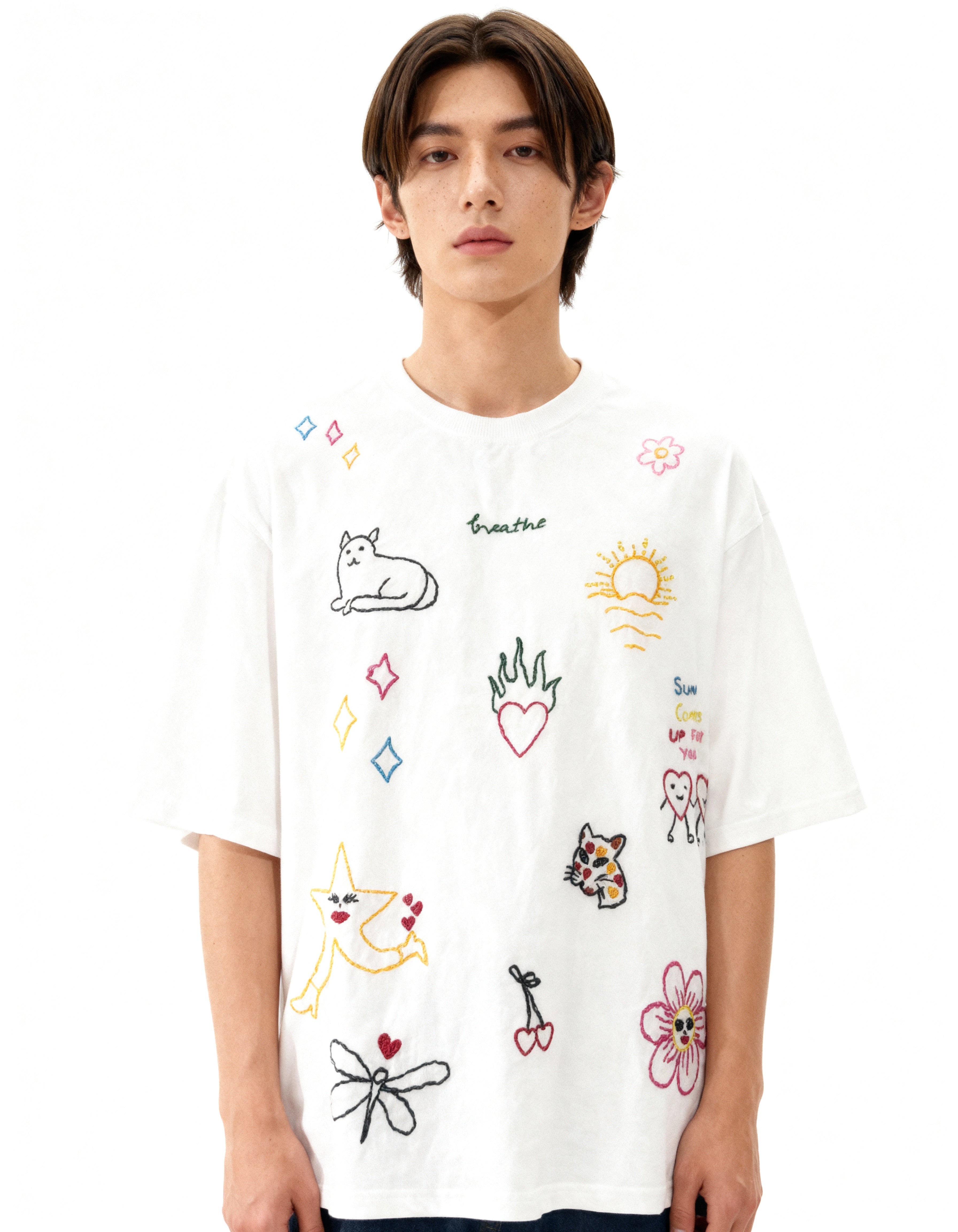 Person wearing a white t-shirt with colorful graphics on a white background