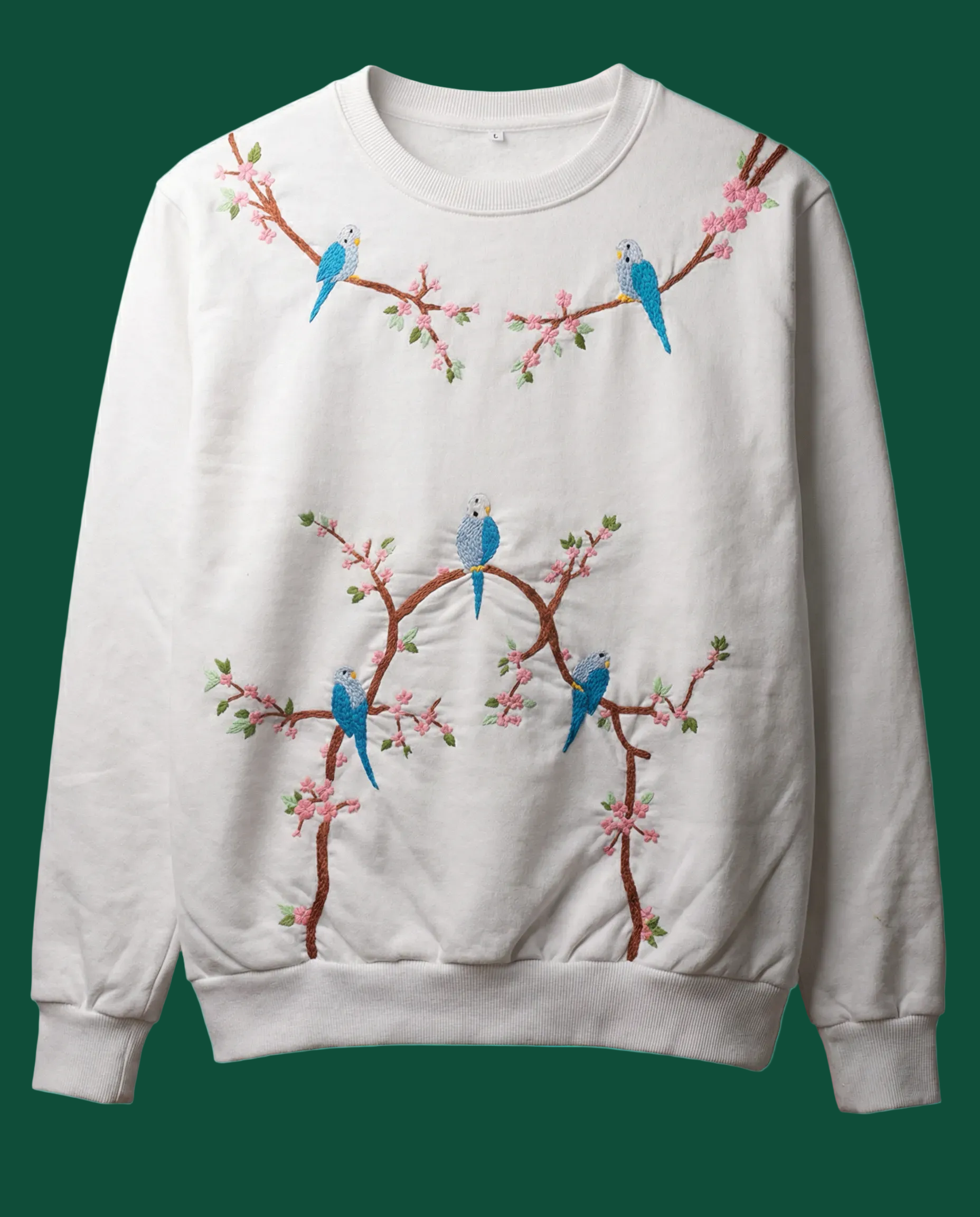 White sweatshirt with bird and sakura branch design on a green background