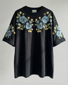 Midnight Garden florals hand-embroidered on a black 220 GSM cotton oversized tee — dark botanical motifs in real thread, oversized unisex fit.