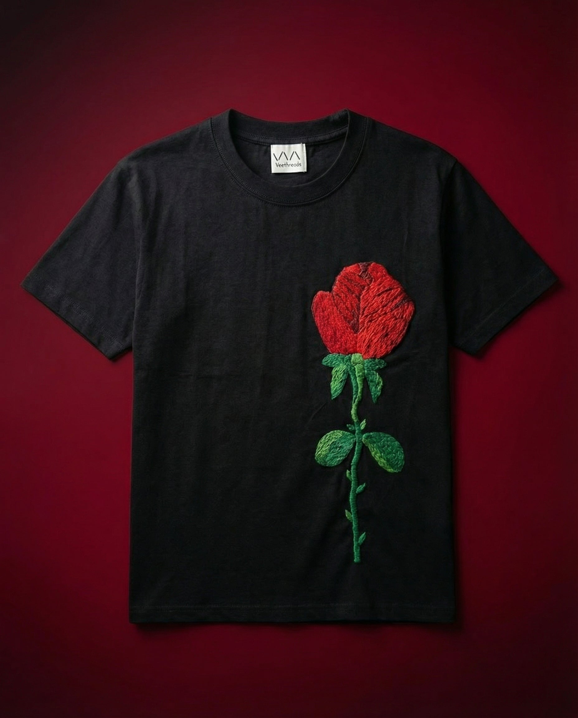 Black t-shirt with a red rose design on a red background