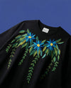 Azure bloom oversized tee — black cotton tee with blue floral hand embroidery in real thread on blue background