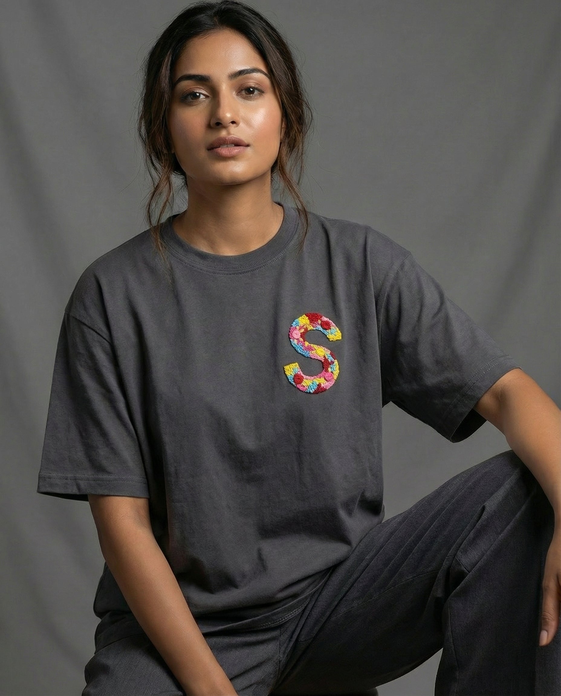 Hand-embroidered custom initials on a 220 GSM cotton tee — real thread, not print, oversized unisex fit.