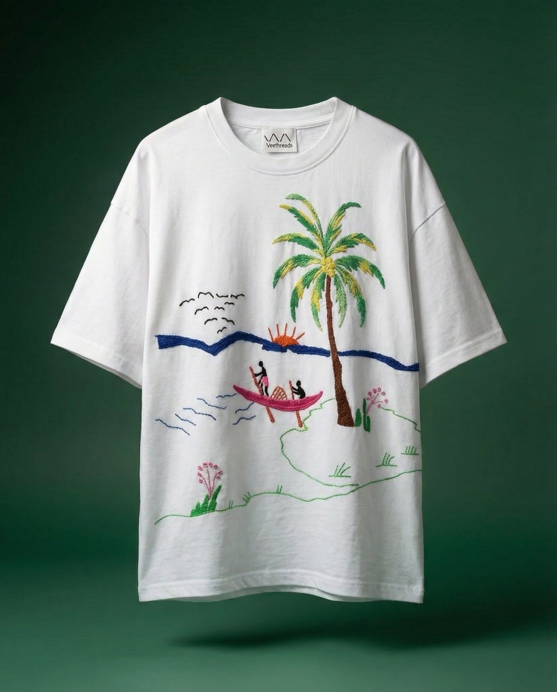 White t-shirt with a tropical beaches embroidery on a green background
