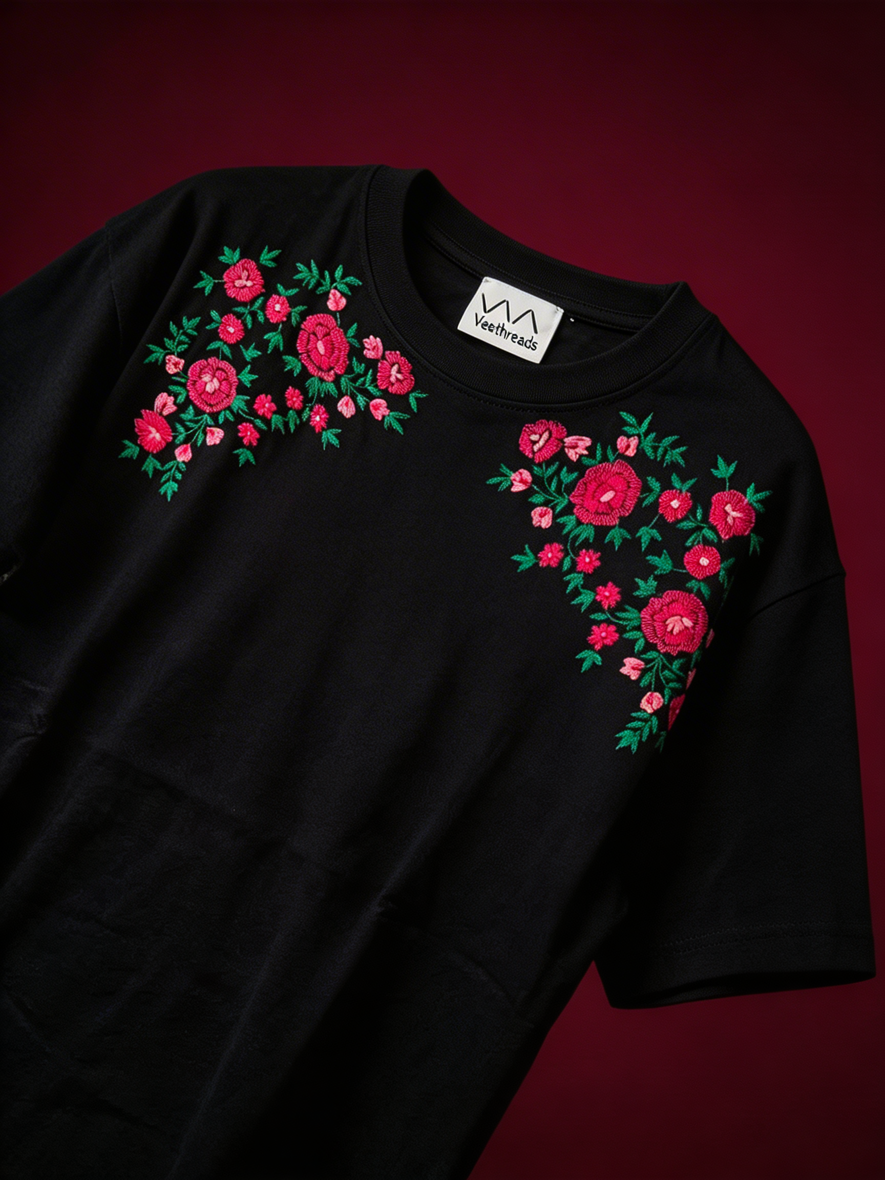 Black t-shirt with floral designs on a red background