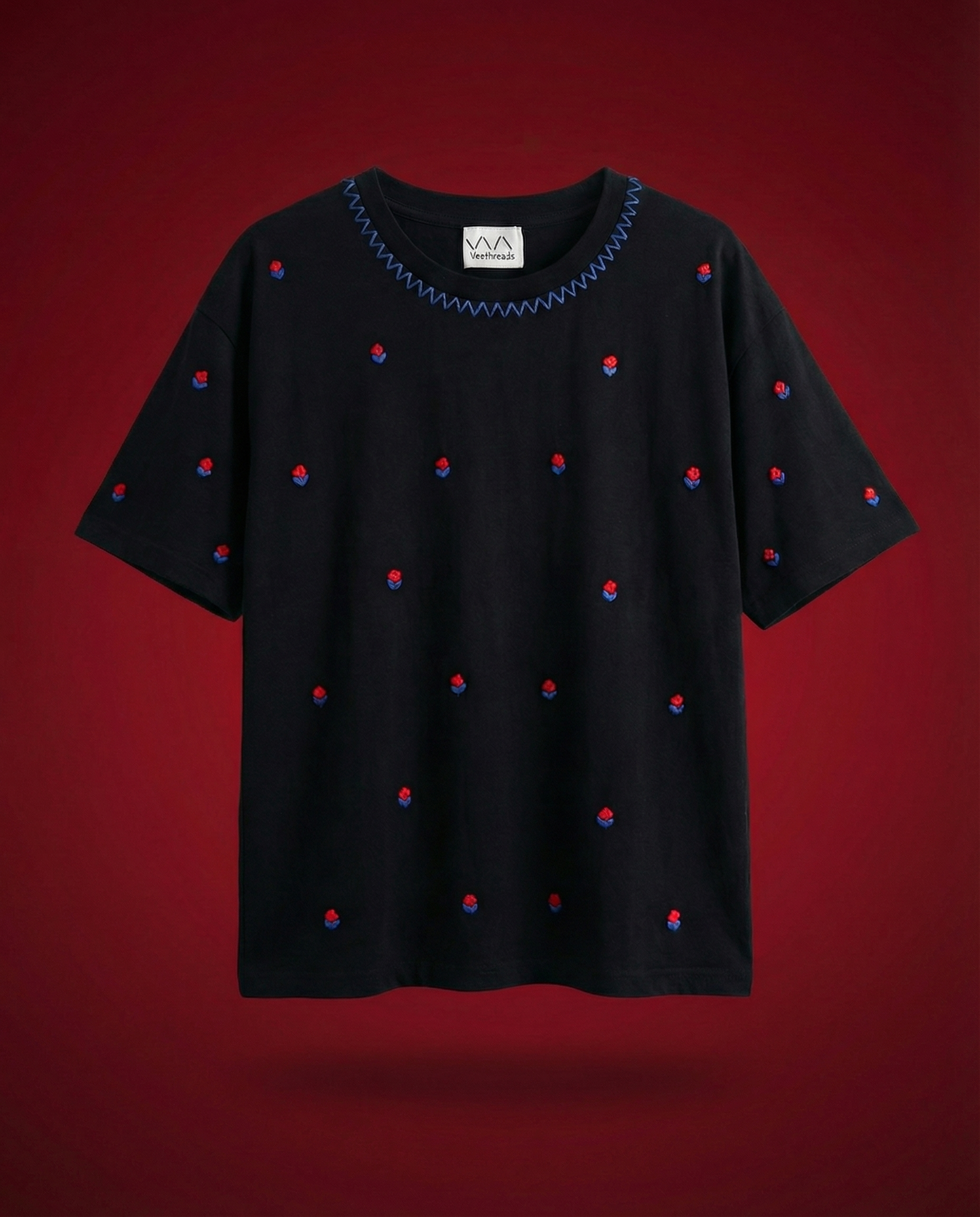 Veethreads Cherry Blossom oversized hand embroidered black t-shirt with red rose and blue leaf motifs — limited edition artisan made