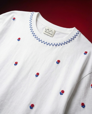 Cherry Blossom hand embroidered black t-shirt with scattered red rose buds and blue zigzag neckline stitch by Veethreads