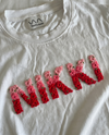 Custom name embroidered double-shade tee — white cotton tee with hand-embroidered floral text design in two thread shades, premium cotton