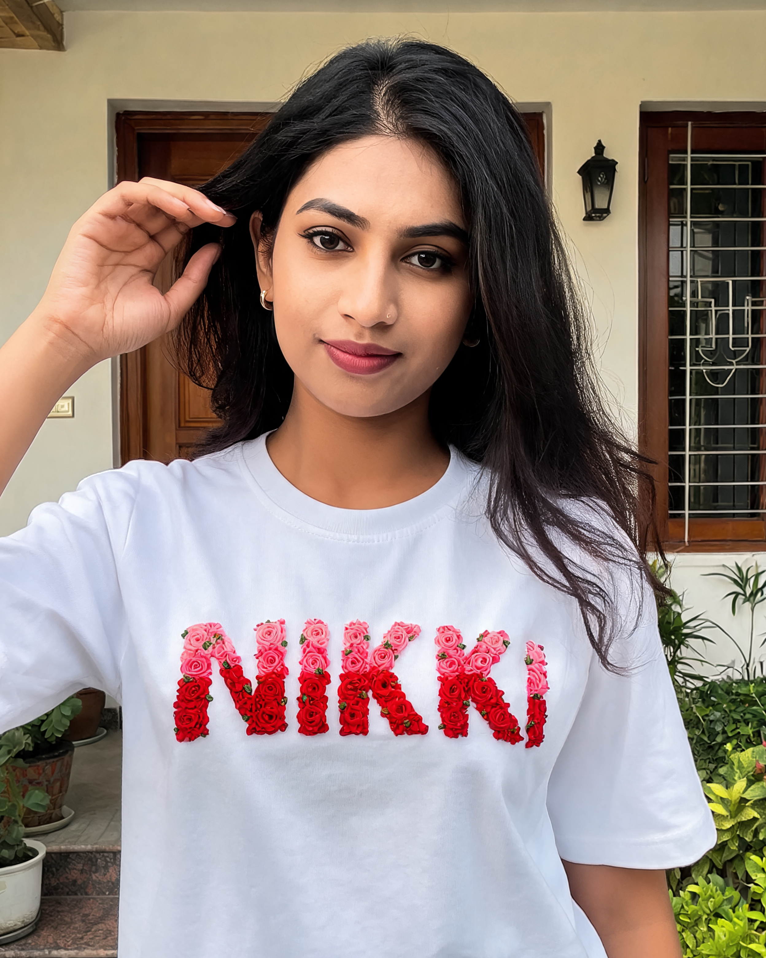 Custom name hand-embroidered in double-shade thread (two blended colours) on a 220 GSM cotton oversized tee — personalised, made to order.