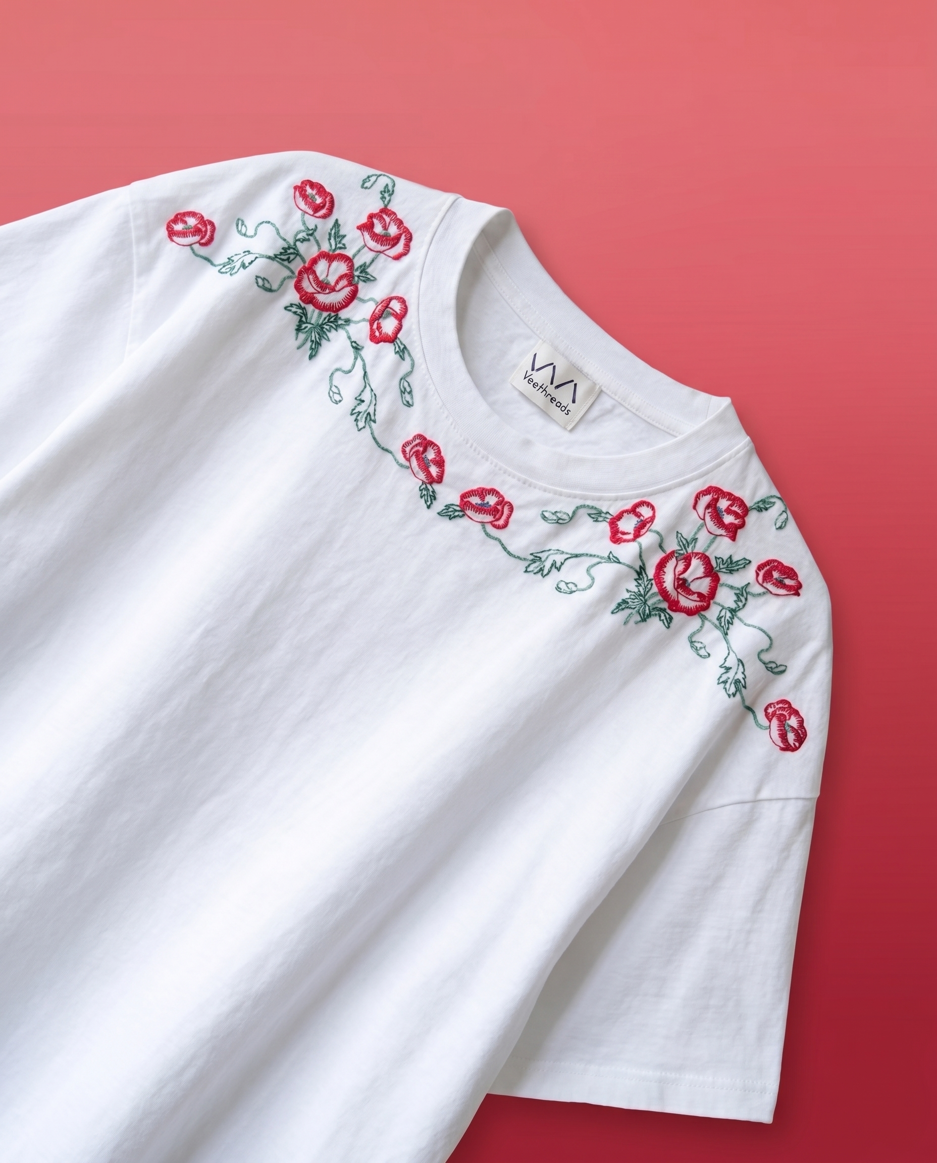 White top with red floral embroidery on a red background ,hand embroidered t shirt
floral embroidered tshirt
rose embroidery tshirt
embroidered oversized tee
handmade embroidered clothing India
luxury embroidered tshirt
artisan embroidered tshirt
aesthetic floral tshirt
premium cotton embroidered tee