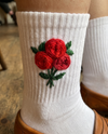 Rose embroidered socks — pair of white cotton hand-embroidered socks with red rose design near cuff, elegant floral stitch