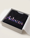 Black sweatshirt with colorful 'Adrian'  custom name text in a box on a white background