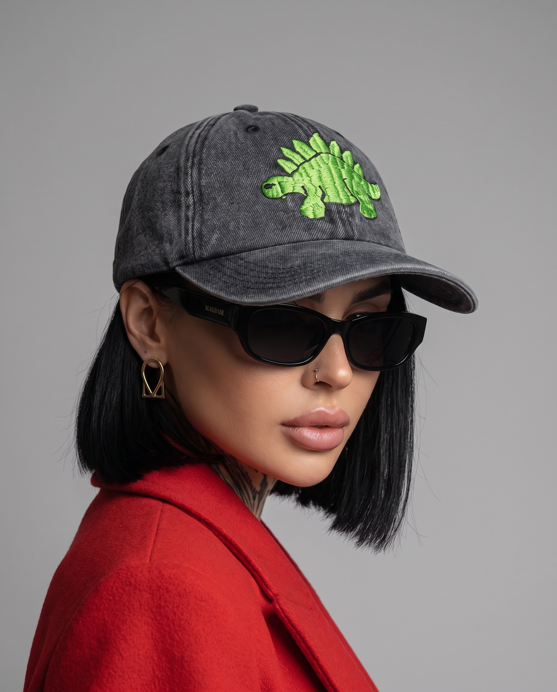 Model wearing Vee Threads dinosaur hand-embroidered denim cap, front view with green dino design