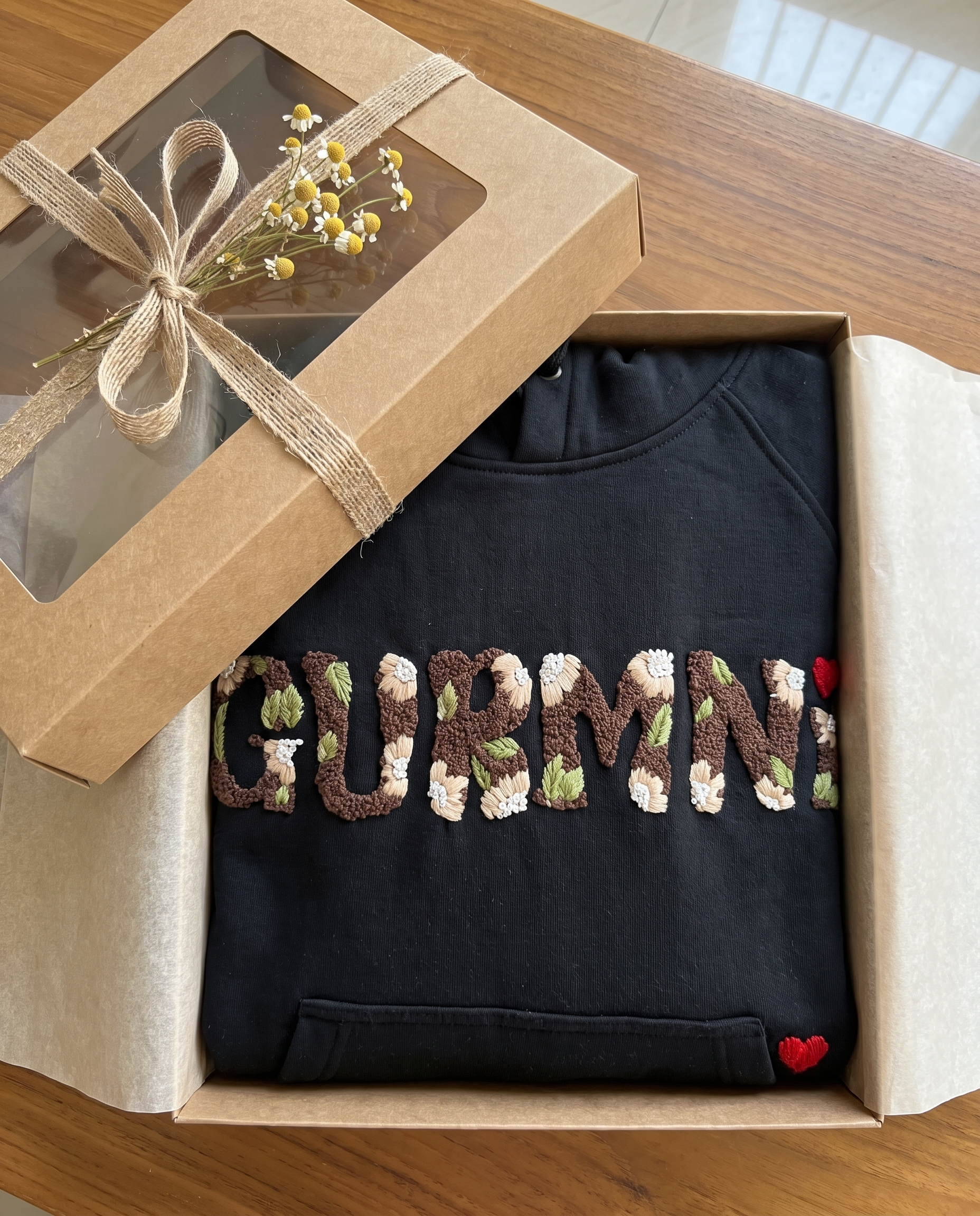 Custom name hoodie packed in a kraft gift box with jute ribbon, name hand embroidered in floral lettering