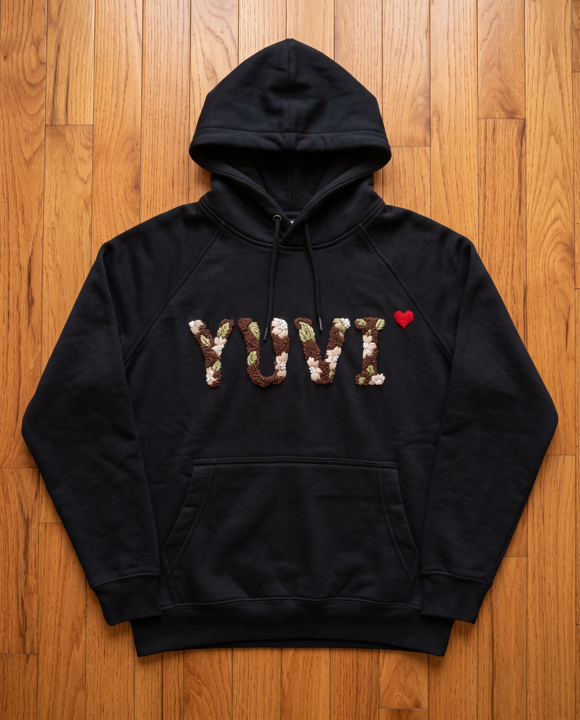 Black oversized hoodie with a custom name hand embroidered across the chest, hood and kangaroo pocket
