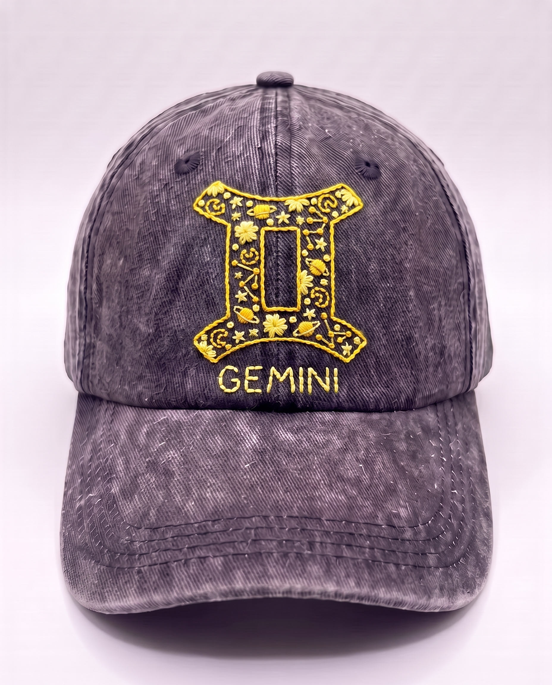 Hand-embroidered Gemini star sign cap in yellow thread on washed denim