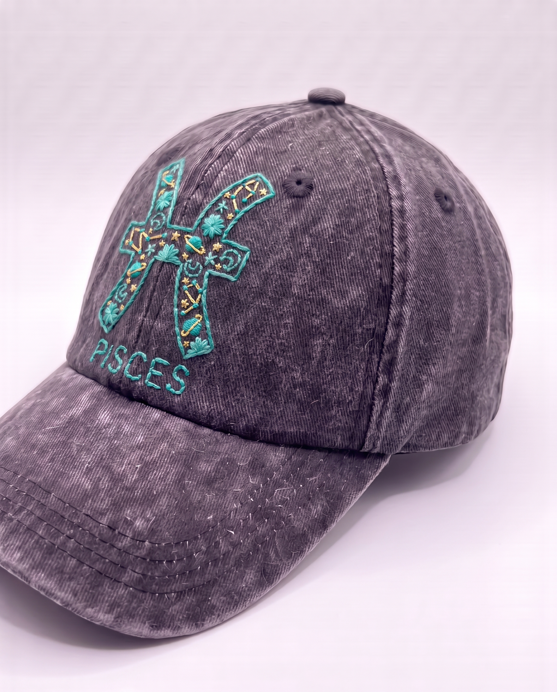Pisces zodiac embroidered cap by Vee Threads, sea green and teal thread on washed denim