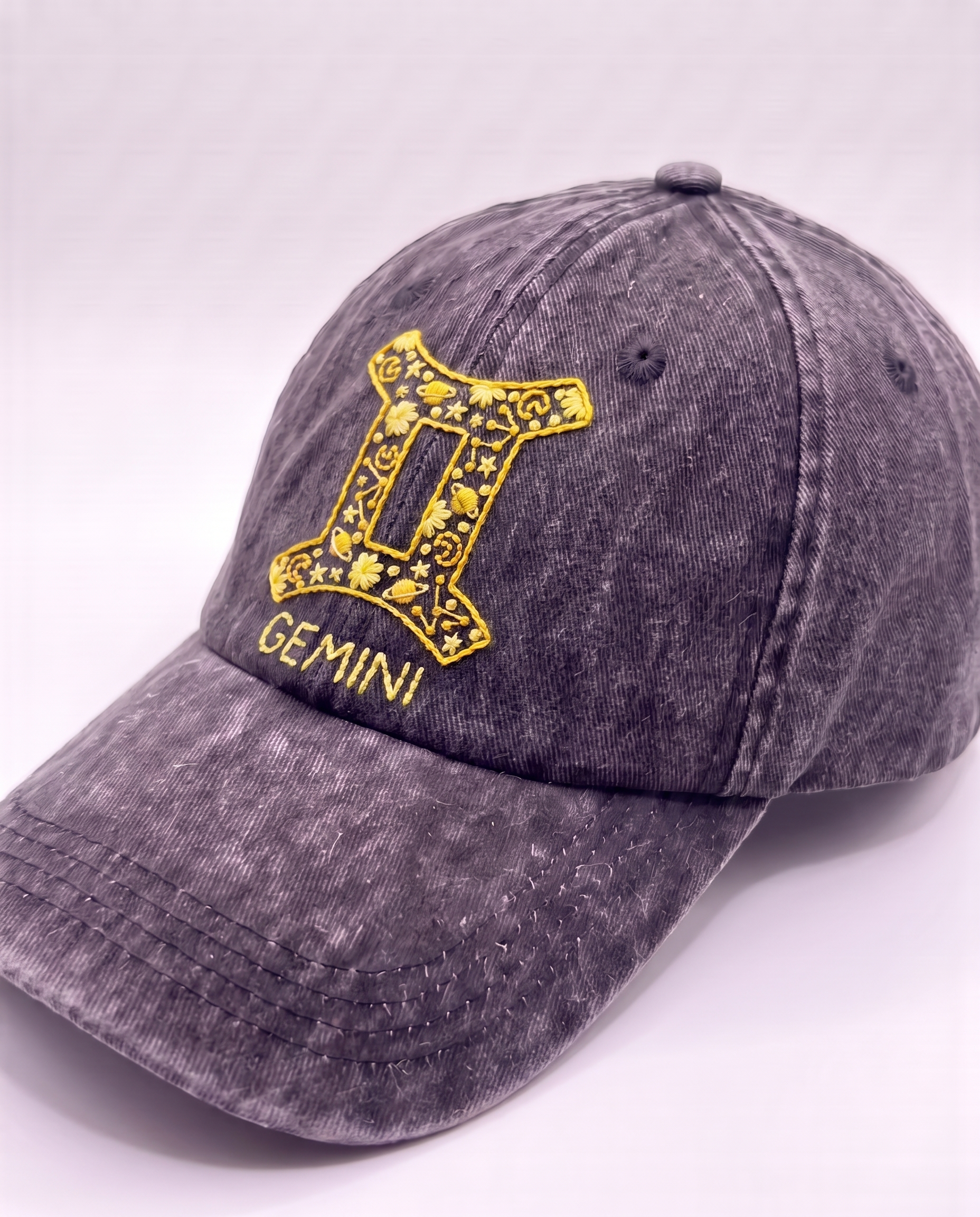 Gemini zodiac cap from the Vee Threads all signs range, yellow twins glyph on acid-wash denim