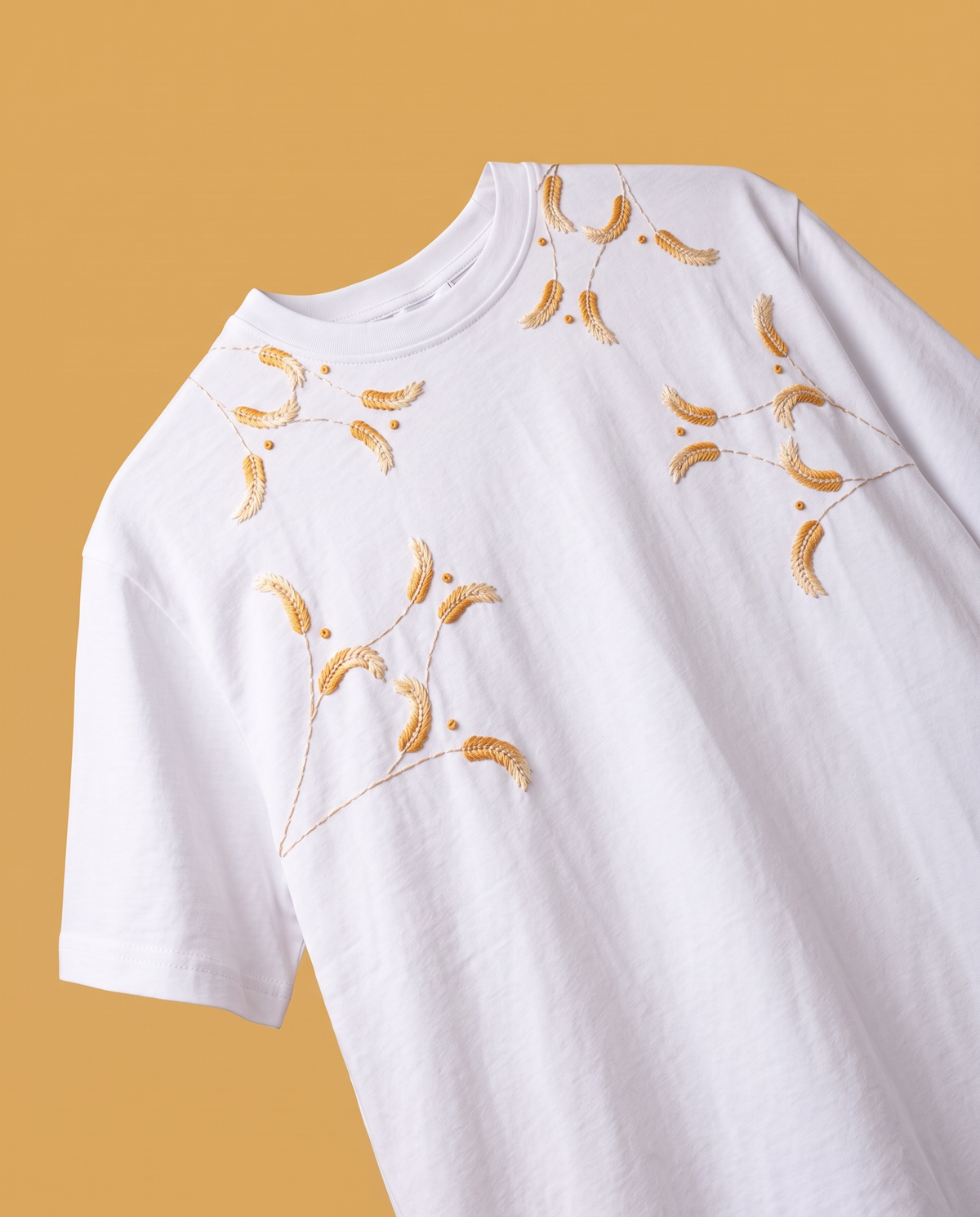 Black 220 GSM cotton t-shirt with mustard and cream hand-embroidered wheat sprigs and French knots