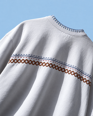 Taanka kantha work t-shirt in white with hand-embroidered chest stripe and blue blanket-stitched collar, front view