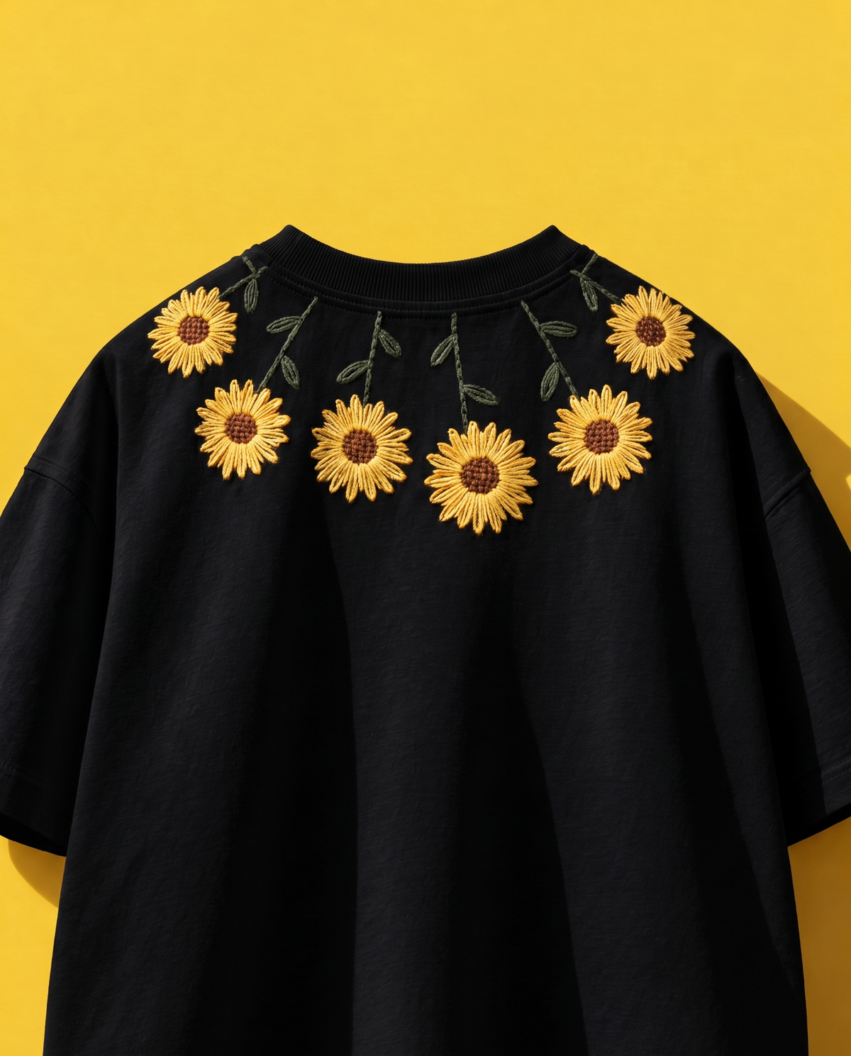 Black sunflower embroidered t-shirt with yellow sunflowers stitched around the collar