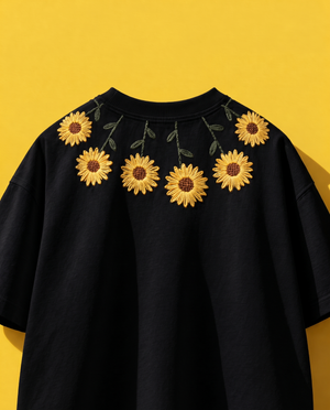 Black sunflower embroidered t-shirt with yellow sunflowers stitched around the collar