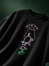 Alien cow hand-embroidered black oversized t-shirt with a purple UFO beaming up a white cow