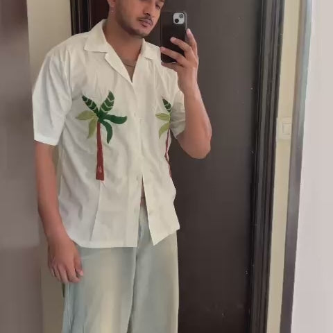 White cotton shirt with hand-embroidered coconut tree – chill beach vibes stitched with desi hands.