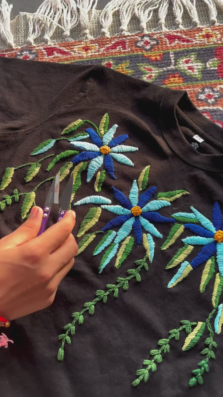 Video of the Azure Bloom oversized tee with cascading blue flowers and vines hand-embroidered