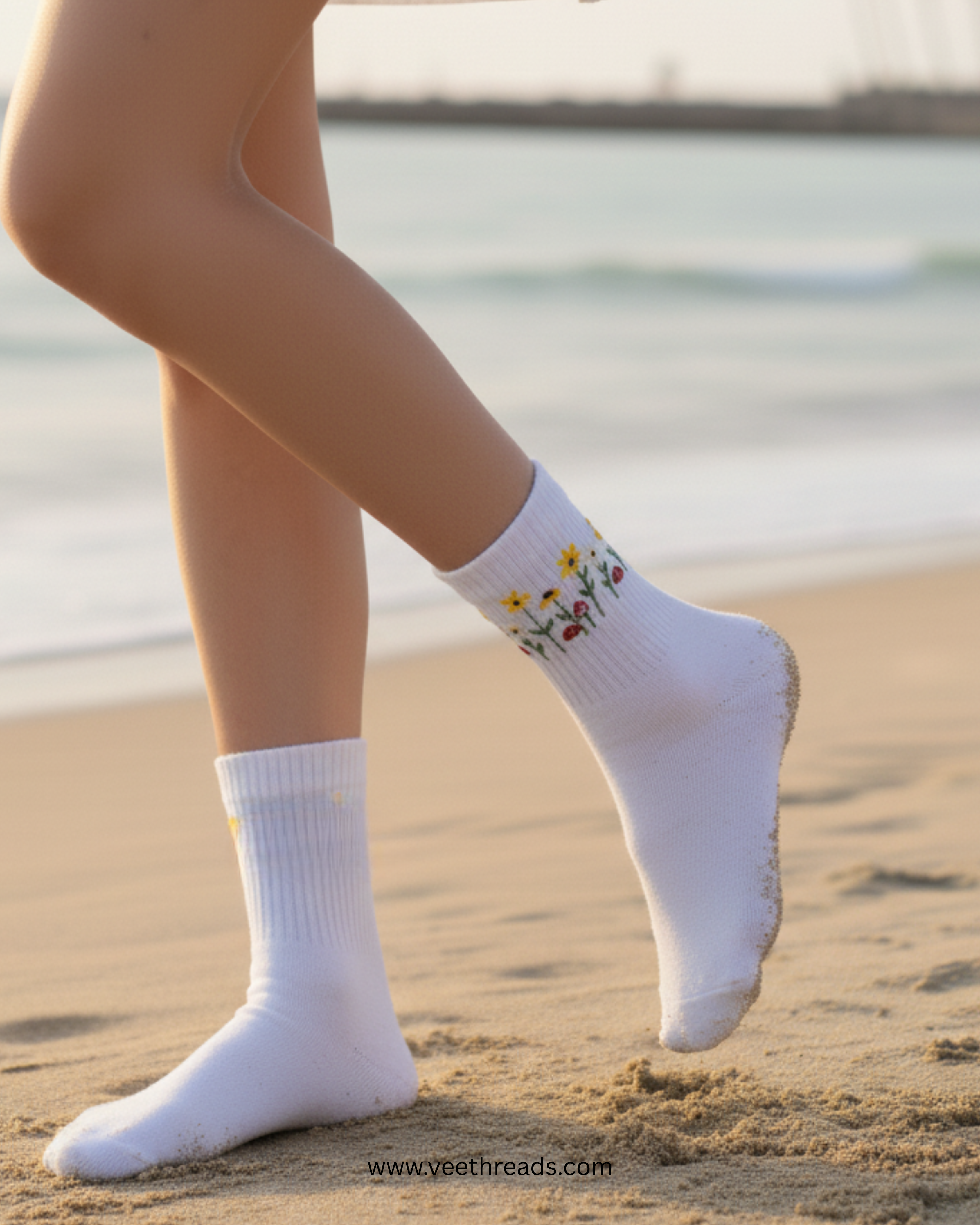 White socks with floral design worn on a beach